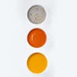 Three white bowls of pureed food